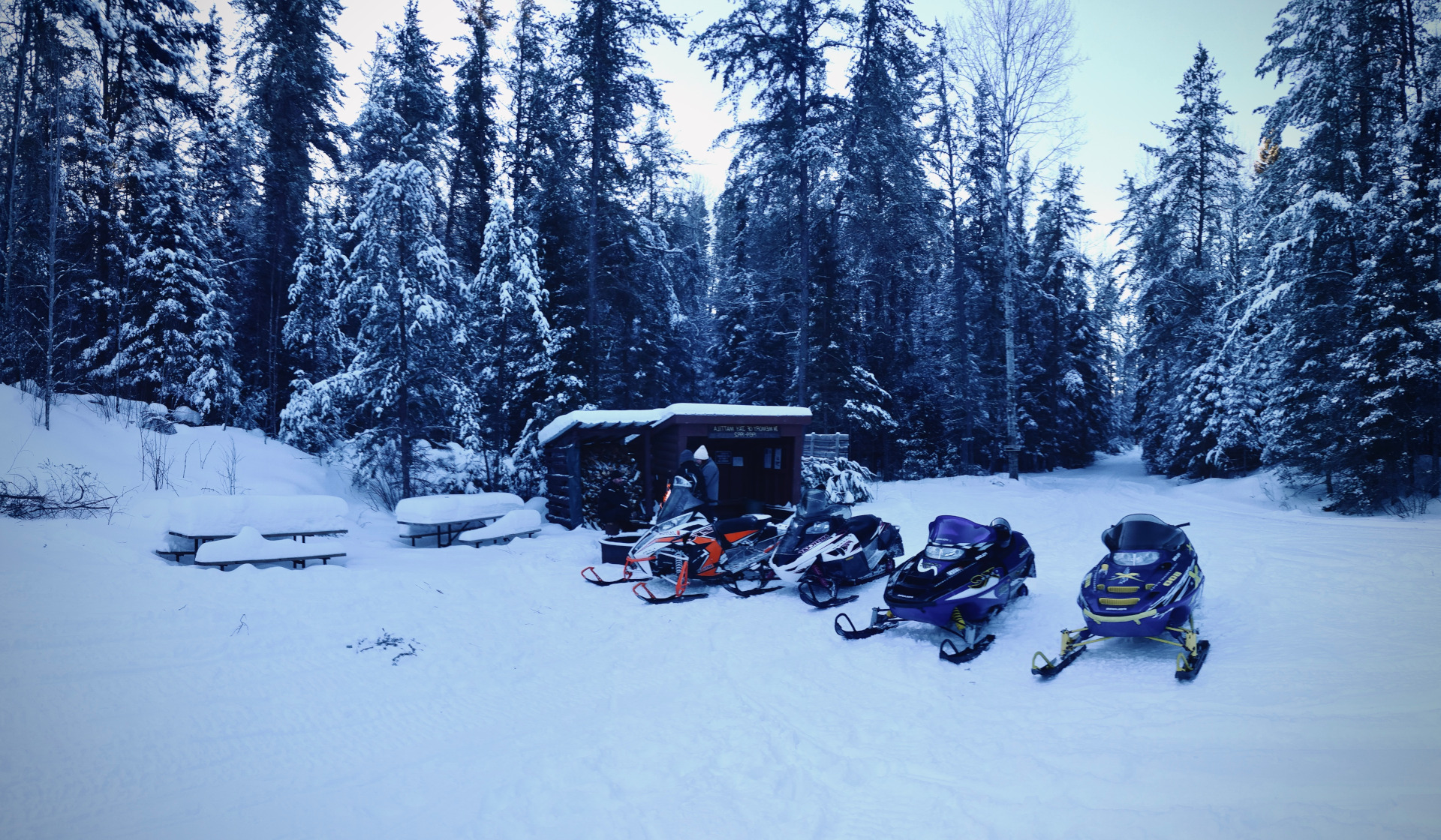 Snowmobiles parked on a snowy trail near Ely, Minnesota